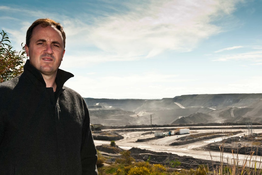 Jeremy Buckingham faces away from the mine at Mt Thorley.