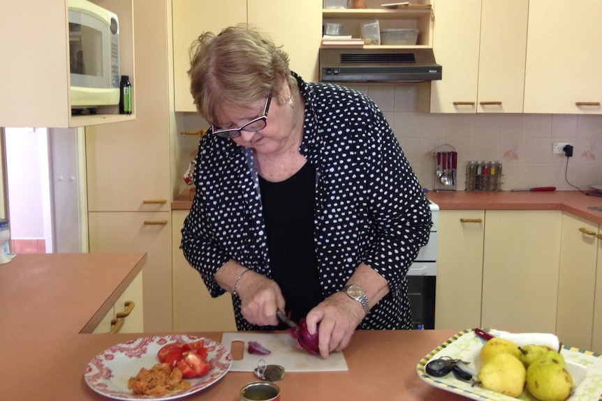 Retiree Pam Kenyon chopping food in her Port Macquarie home.