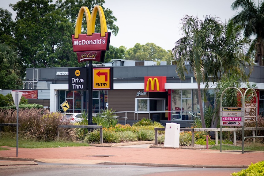 A McDonalds store on a street corner, seen from the outside