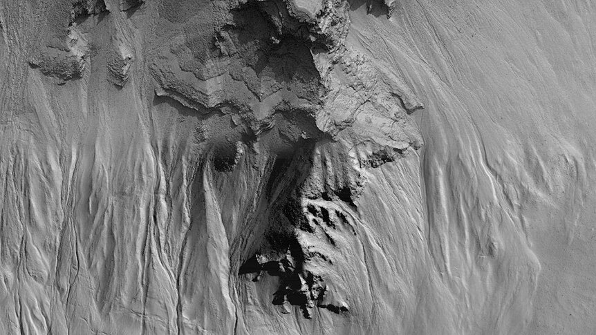 Layers and gullies in a crater in central Noachis Terra on Mars.