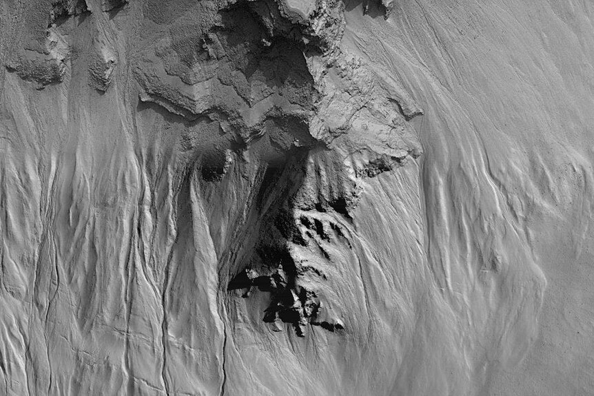 Layers and gullies in a crater in central Noachis Terra on Mars.