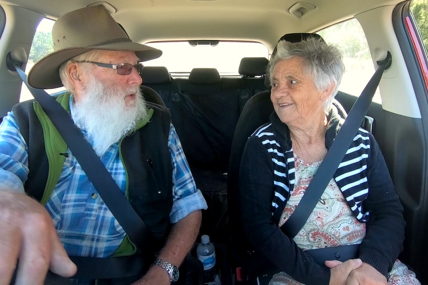 An older couple in a car.