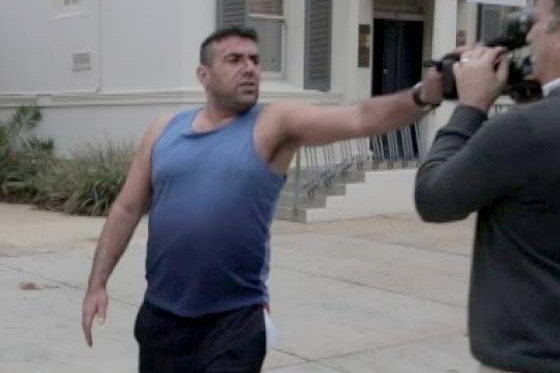 Abbas Allami scuffles with an ABC cameraman outside court in 2015.