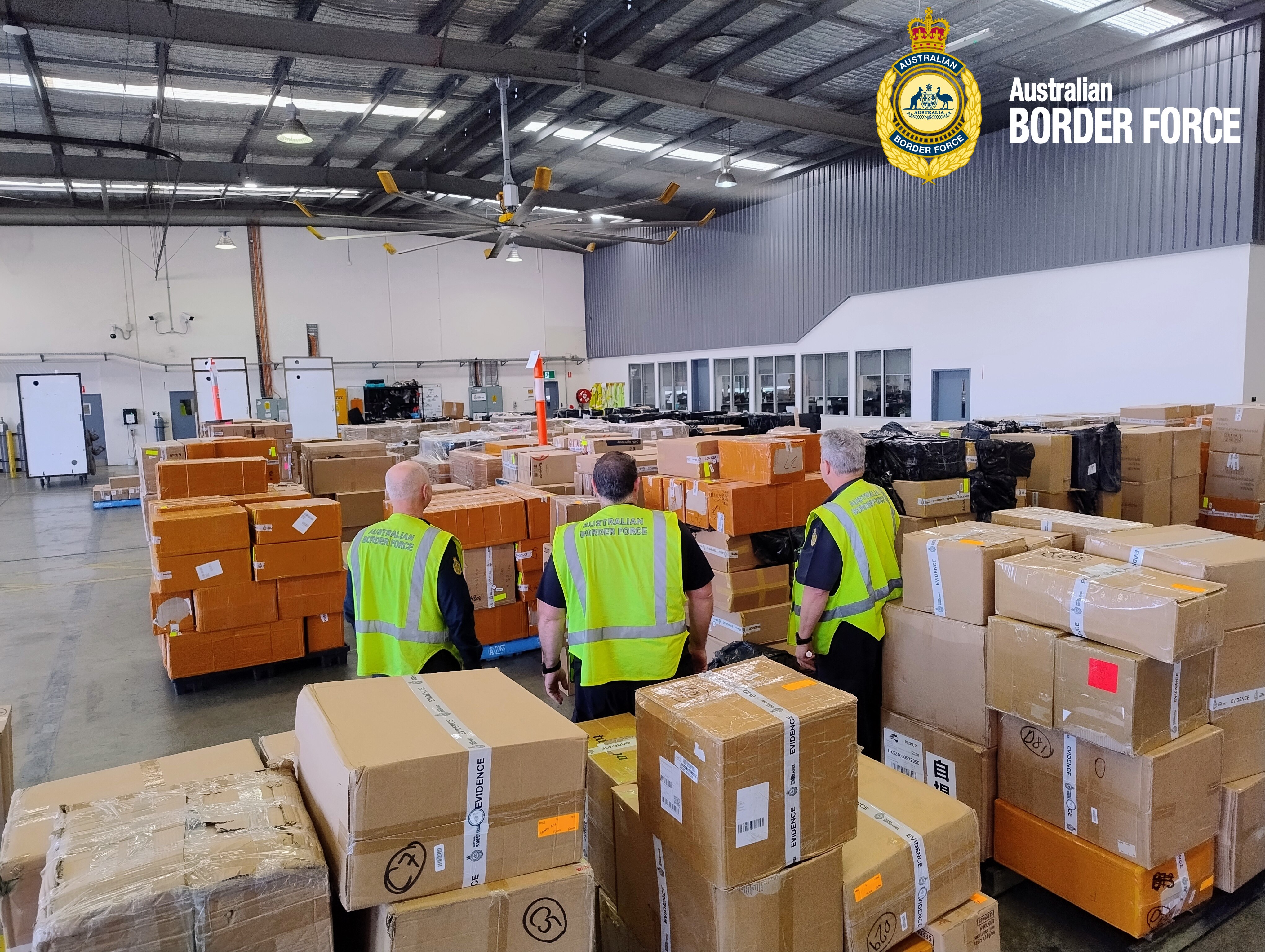 Three offices look at warehouse of boxes 