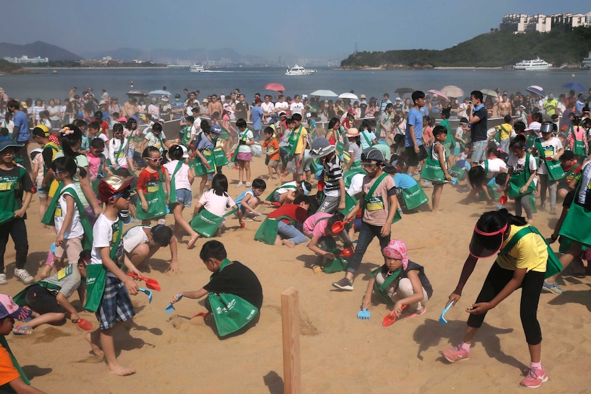 Children looked for eggs hidden in the sand at Hong Kong's Tai Pak Beach.