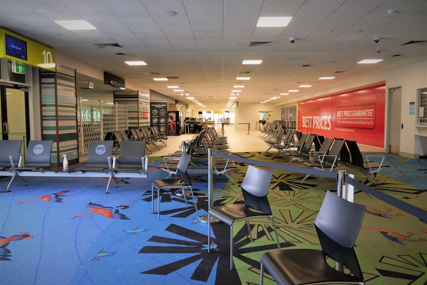 Airport terminal launch with chairs and bright carpets.