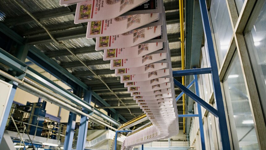 dozens of copies of the advocate being printed on a press