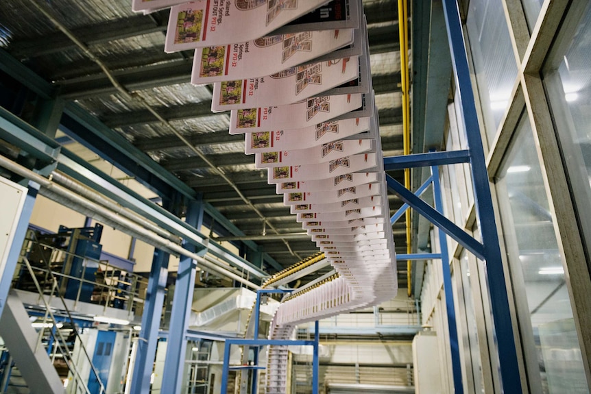 dozens of copies of the advocate being printed on a press