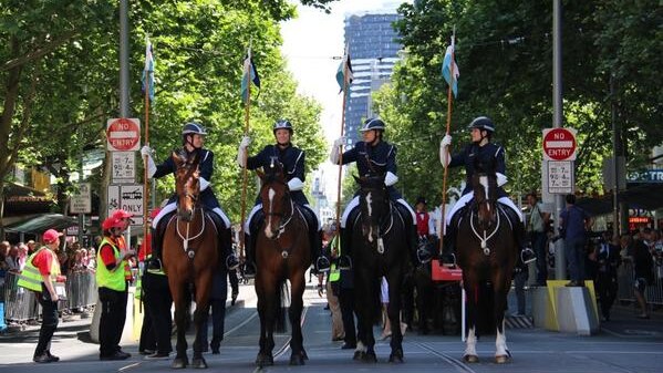 Mounted police make their way down Swanston St
