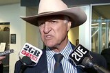 Bob Katter speaks to the media after arriving at Canberra Airport