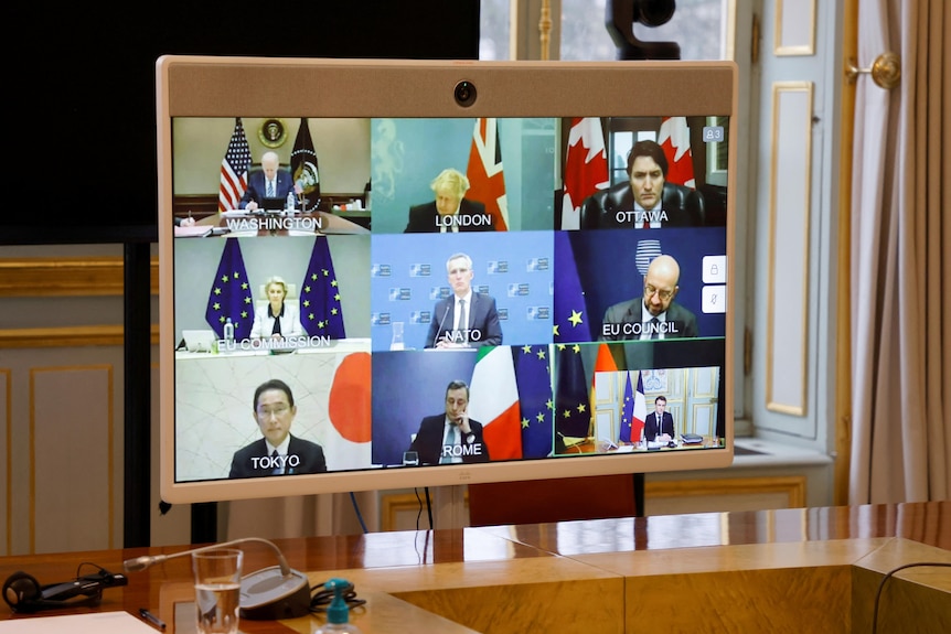 G7 leaders on screen.