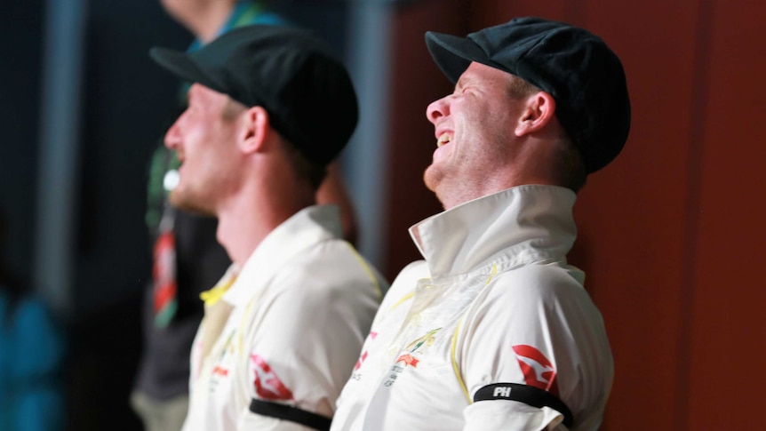 Steve Smith laughs, with Cameron Bancroft in the background.