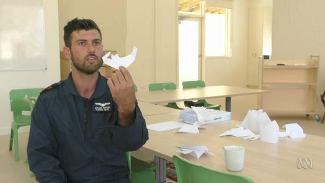 Man holds paper plane