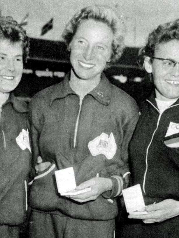 Shirley Strickland holds her gold medal after victory in the 80m Hurdles at the 1956 Melbourne Olympics.