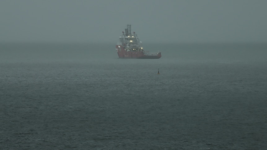 A ship in Darwin harbour in rainy gloomy weather