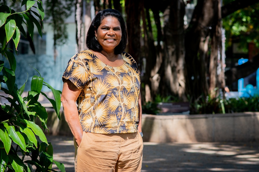 Labor Lingiari candidate Marion Scrymgour, standing outside on a sunny day and smiling at the camera. 