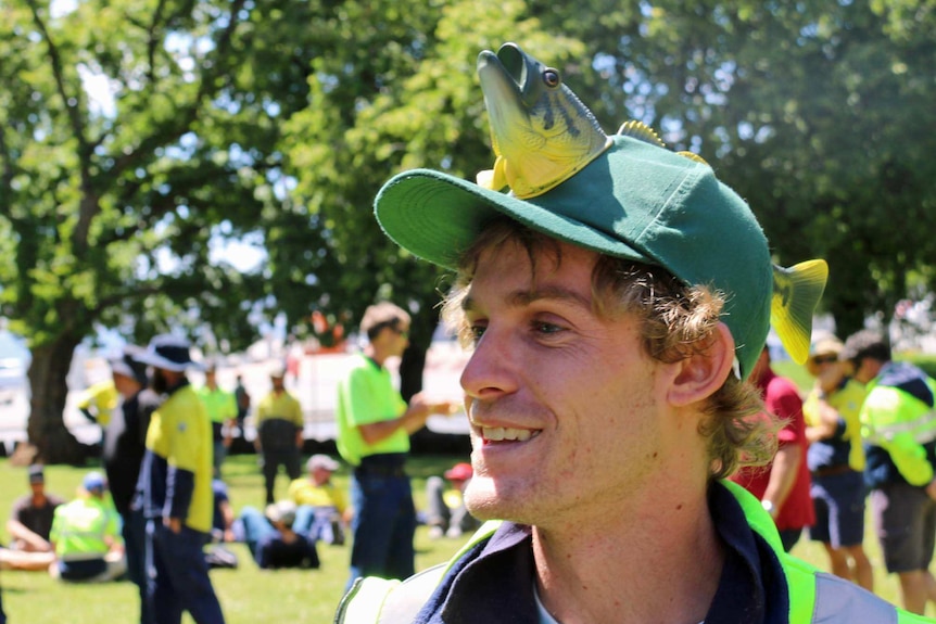 Man with a fish hat attends a salmon industry rally