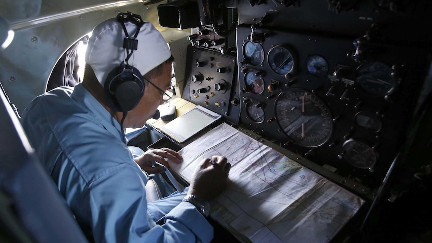 Military official searches for missing Malaysia Airlines plane