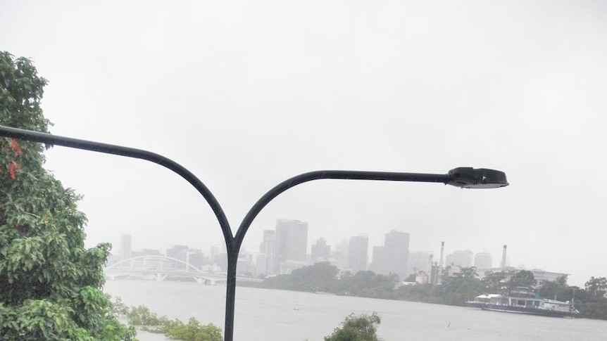 The Brisbane River is rising towards a devastating record flood peak.