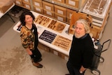 Sylvana Szydzik and David Roe from the Port Arthur Historic Site look up from amongst shelves of artefacts.
