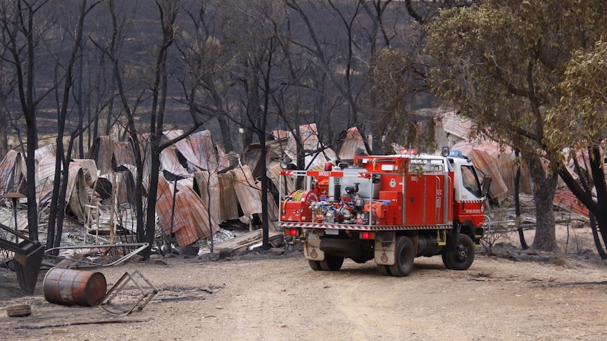 A fire engine in front of a burnt-out property near Carwoola.