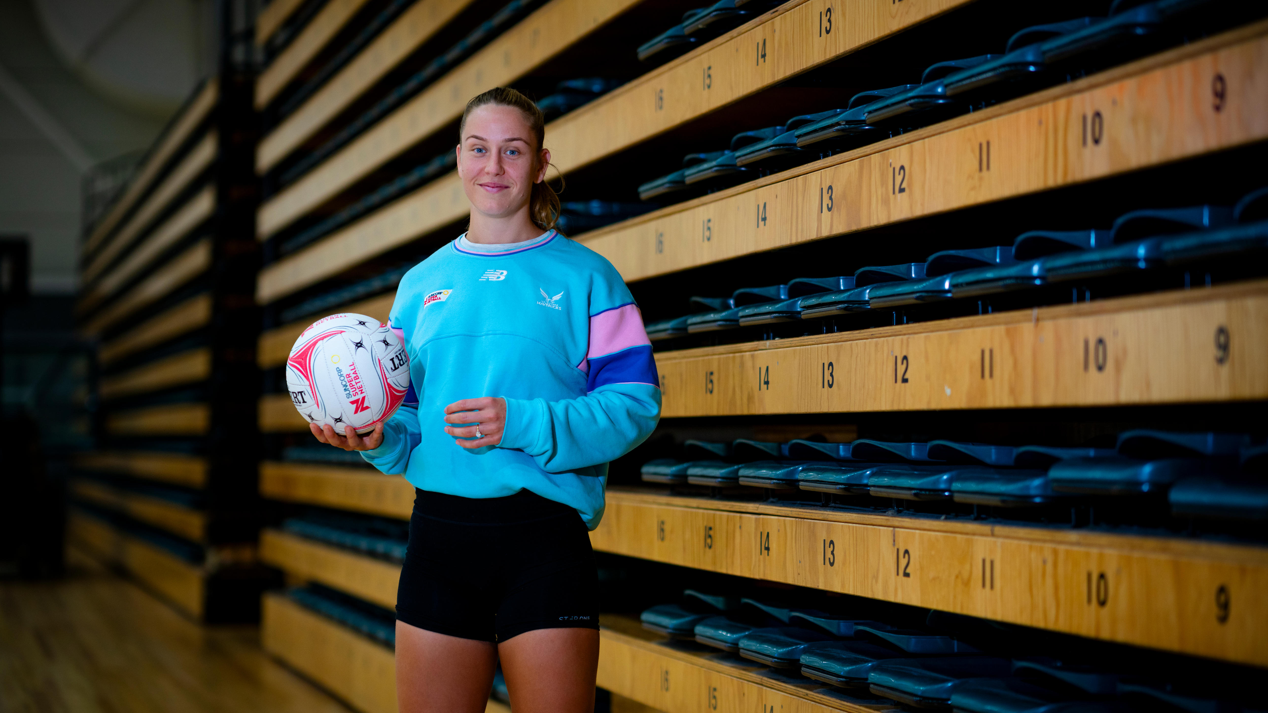 Netballer Jamie-Lee Price holds a netball in hand.