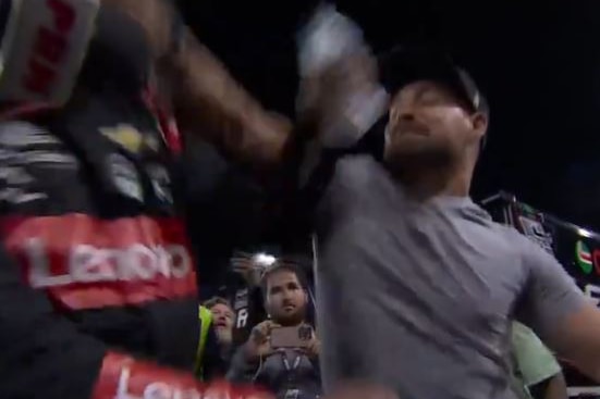A screenshot of a man punching another man