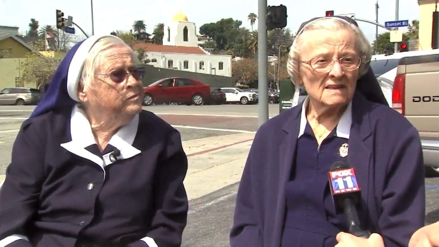 Two nuns speak to a reporter.