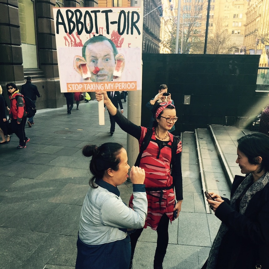 Woman with sign at protest rally