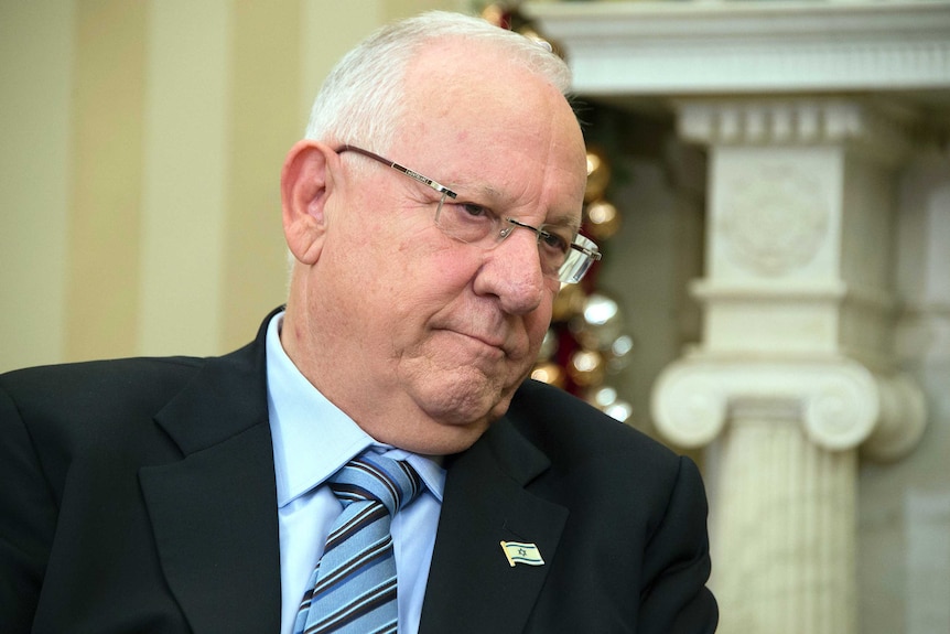 Medium close-up picture of Israeli President Reuven Rivlin sitting down.