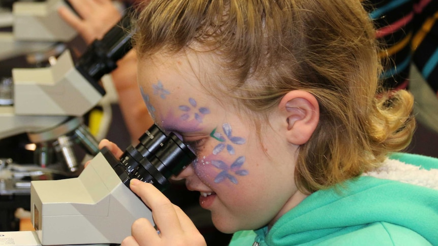 Children looking through microscopes.