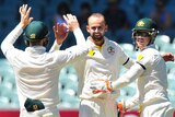 Nathan Lyon celebrates the wicket of Wriddhiman Saha on day four of the first Test at Adelaide Oval