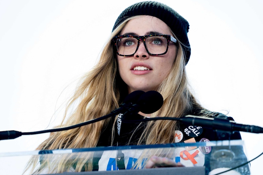 Tight shot of a woman speaking at a lectern.