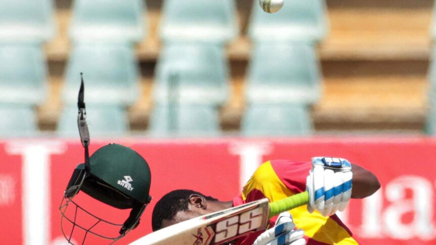 The helmet of Zimbabwe batsman Richmond Mutumbami flies off after he is hit in the head by the ball.
