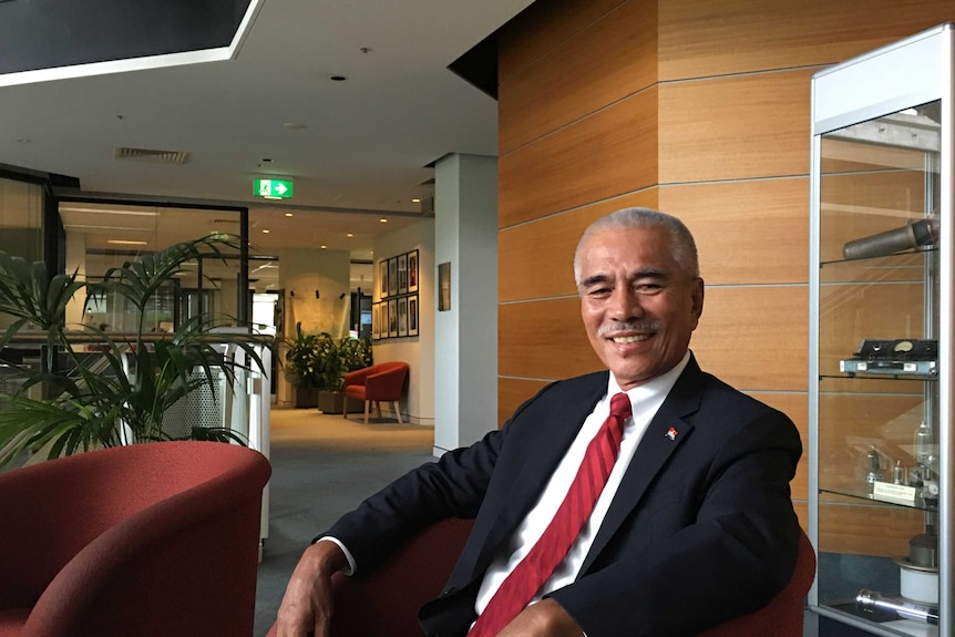 Former Kiribati president Anote Tong sits, relaxed in a comfortable tub chair and is smiling