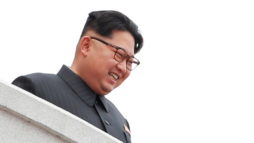North Korean leader Kim Jong-un smiles from the balcony