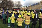 Firefighters rally at Parliament House in Hobart over funding.