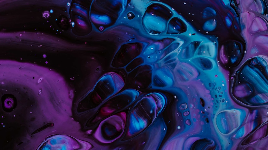 Liquid paints in blue and purple colours swirl together, creating patterns and bubbles