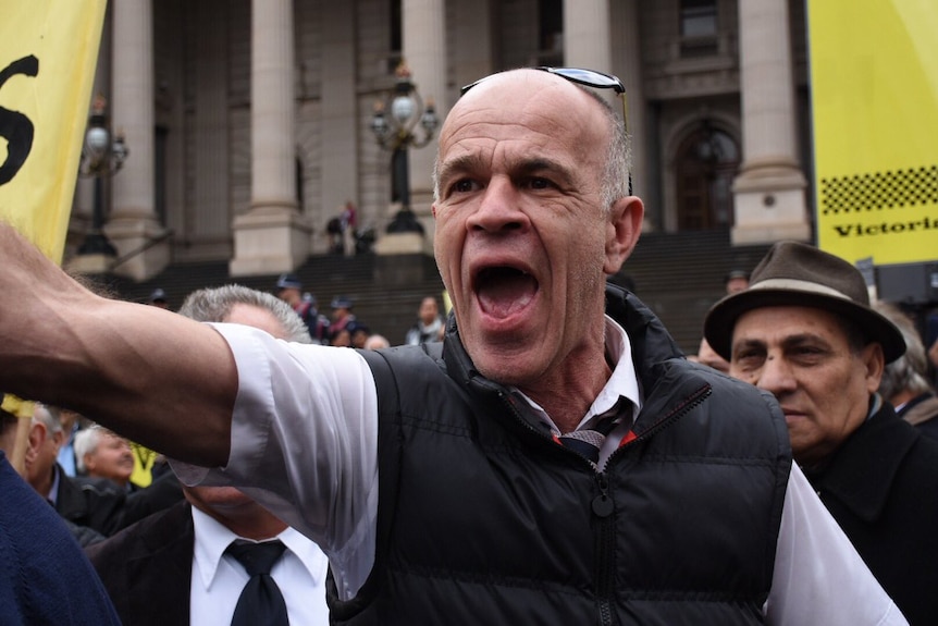 An angry taxi driver yells during a protest at Parliament House in Melbourne.