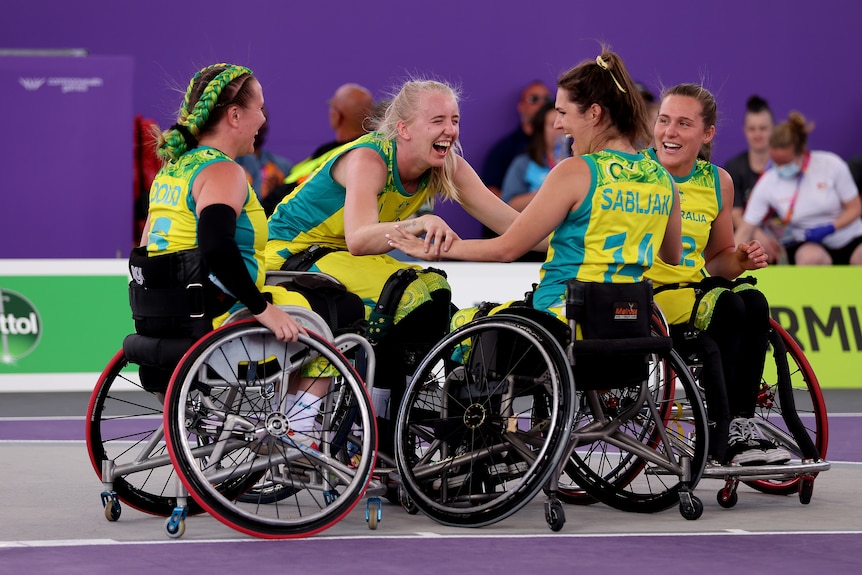 Australia's wheelchair basketball team celebrate in a circle