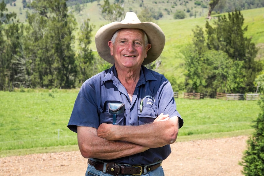 Rod Kater stands cross-armed on a farm.