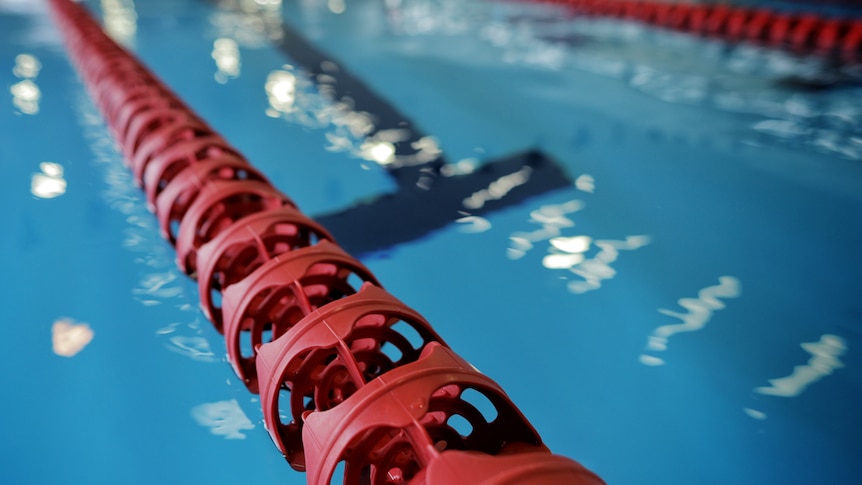 Big red lane ropes in a swimming pool.