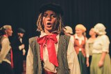 A young boy dressed as a French street urchin for the Les Mis production.