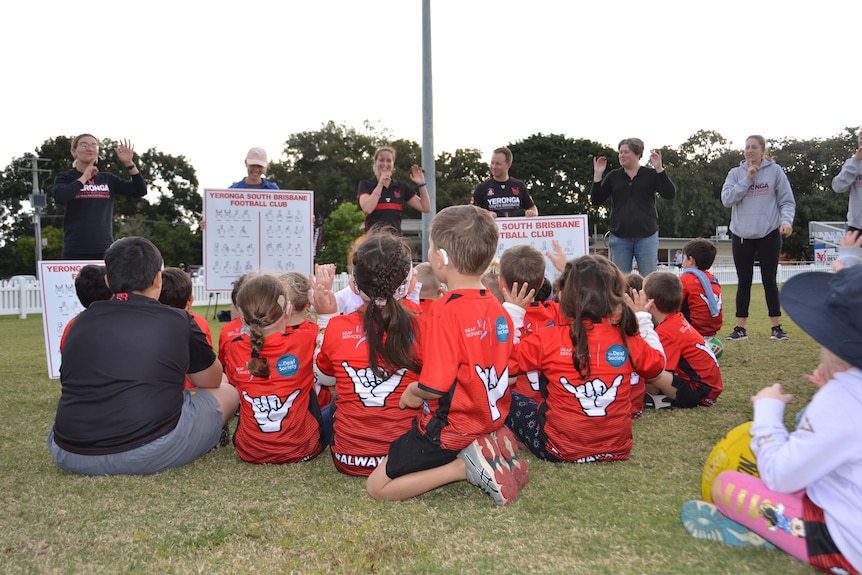 Children learning Auslan Aussie rules at Yeronga Devils team song
