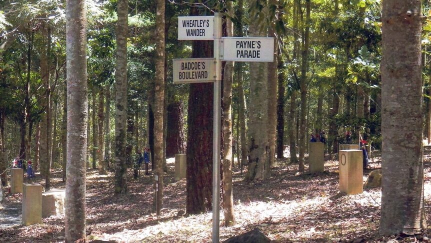 A forest grove with a signpost featuring thoroughfares named after Australian soldiers.