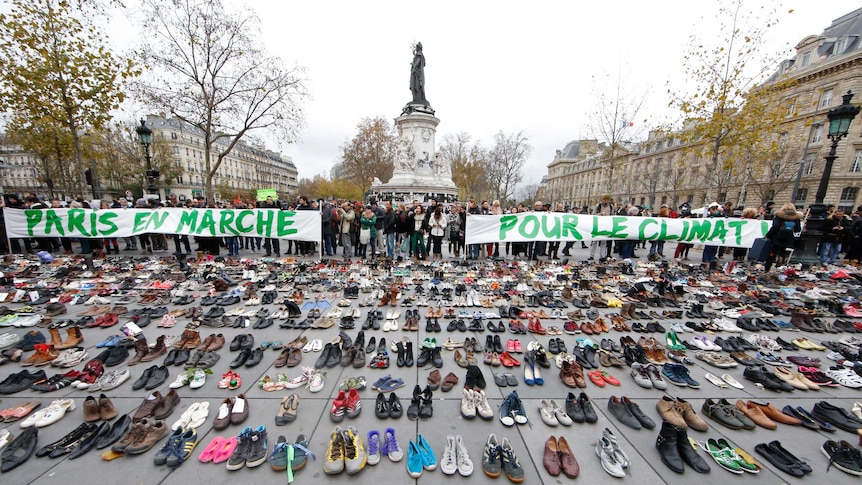Banners are displayed among hundreds of pairs of shoes on the Place de la Republique in Paris.