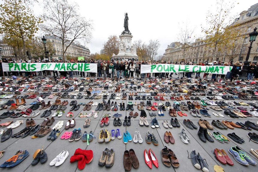 Banners are displayed among hundreds of pairs of shoes on the Place de la Republique in Paris.