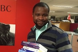 Alphonse Mulumba with donated books