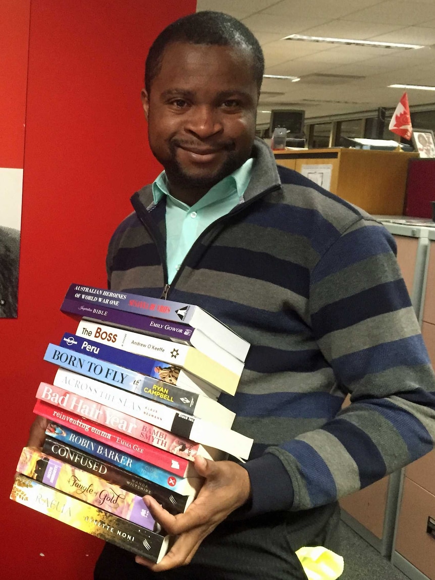 Alphonse Mulumba with donated books