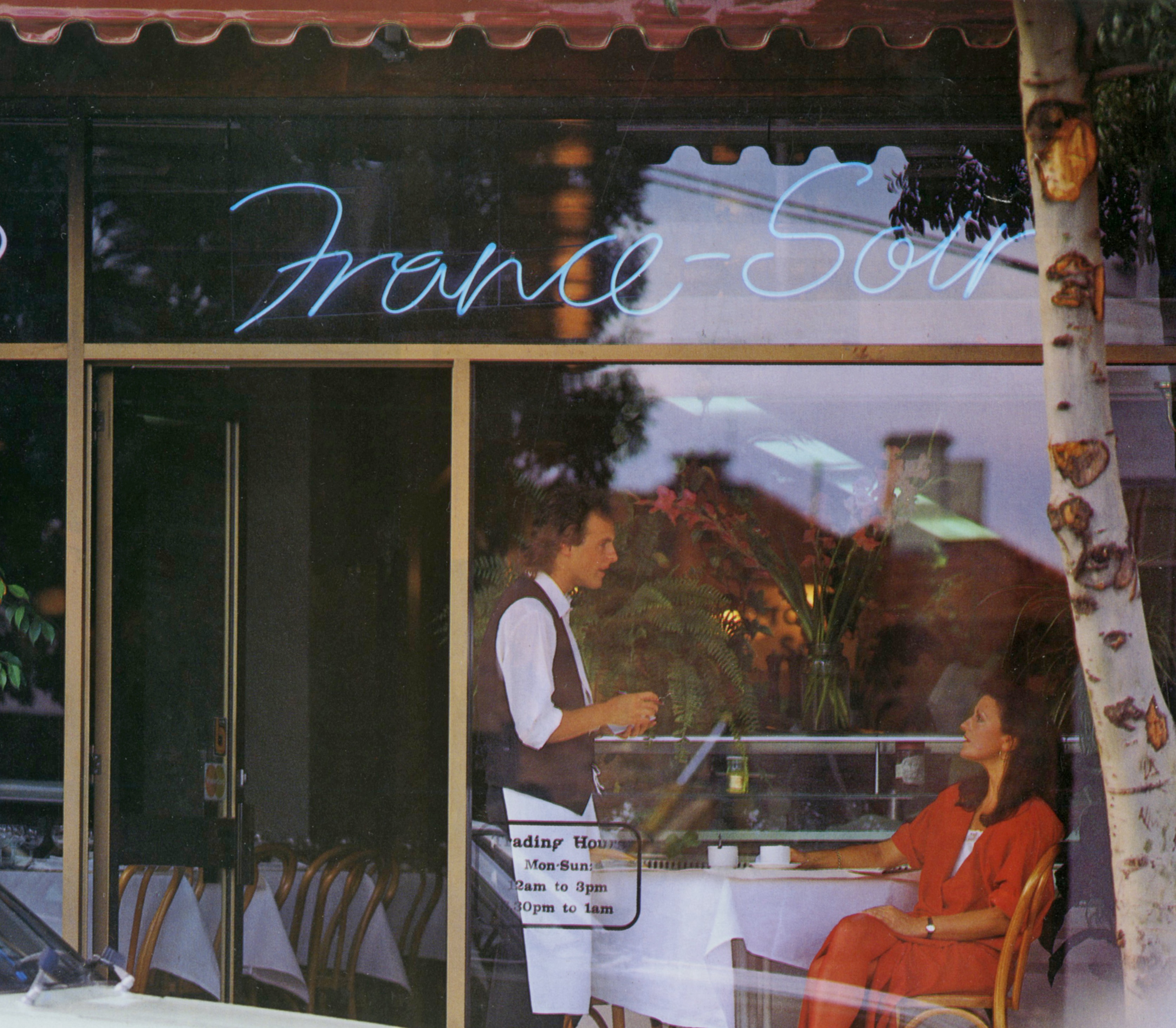 A waiter is seen through the window of French restaurant France-Soir